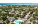 Wide aerial perspective of apartments, community pool, parking, and green space highlighting a residential neighborhood at 12156 Melody Dr # 201, Westminster, CO 80234