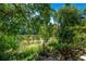 Backyard landscape view of a pond and mature foliage at 12156 Melody Dr # 201, Westminster, CO 80234