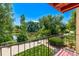 View from the balcony overlooking a pond, greenery, and neighborhood homes at 12156 Melody Dr # 201, Westminster, CO 80234