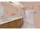 Bathroom features double sinks, tile floors, tile tub surround, and a colorful shower curtain at 12156 Melody Dr # 201, Westminster, CO 80234