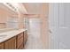 Bathroom features double sinks, tile floors, tile tub surround, and a colorful shower curtain at 12156 Melody Dr # 201, Westminster, CO 80234
