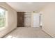 Comfortable bedroom with neutral walls, large window, and a closet with sliding doors, providing ample storage space at 12156 Melody Dr # 201, Westminster, CO 80234