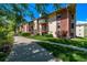 A view of the apartment building showcasing balconies, landscaping, and an inviting walkway at 12156 Melody Dr # 201, Westminster, CO 80234