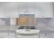 Kitchen with an electric stove, built in vent, light grey countertops, and seamless flow to the dining area at 12156 Melody Dr # 201, Westminster, CO 80234