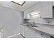Well-maintained kitchen features ample countertop space, white cabinets, and stainless steel sink for easy meal prep at 12156 Melody Dr # 201, Westminster, CO 80234