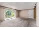 Spacious living room featuring a large sliding glass door with balcony access and neutral carpet at 12156 Melody Dr # 201, Westminster, CO 80234