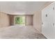 Spacious living room with plush carpeting and a sliding glass door to the balcony, providing ample natural light at 12156 Melody Dr # 201, Westminster, CO 80234