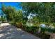 Scenic pond view from the apartment walkway, complete with benches, flowers, and greenery at 12156 Melody Dr # 201, Westminster, CO 80234