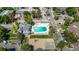 Aerial view of a community pool, playground, and sports court with parking and nearby apartments and townhomes at 12156 Melody Dr # 201, Westminster, CO 80234