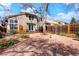 Landscaped backyard with deck, privacy fence and mature trees providing a relaxing outdoor space at 1578 S Syracuse St, Denver, CO 80231
