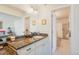 Bathroom with granite countertops, white cabinets, vanity, and a door to a shower at 1578 S Syracuse St, Denver, CO 80231
