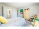 Bedroom featuring a whimsical Paris-themed art piece, dresser and chair with a bright yellow accent pillow at 1578 S Syracuse St, Denver, CO 80231
