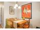 A cozy dining area features a wooden table and chairs, vintage poster art, and natural light at 1578 S Syracuse St, Denver, CO 80231