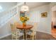 Charming dining area next to the staircase, featuring a wooden table, padded chairs, and elegant decor at 1578 S Syracuse St, Denver, CO 80231