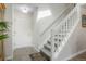 Welcoming entryway with tile flooring, a staircase, a coat closet, and a neutral color palette at 1578 S Syracuse St, Denver, CO 80231