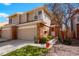 Inviting two-story townhouse featuring a well-maintained lawn, brick accents, and an attached one-car garage at 1578 S Syracuse St, Denver, CO 80231