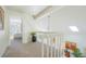 A light filled hallway with a skylight and a view of a bedroom at 1578 S Syracuse St, Denver, CO 80231