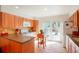 Cozy kitchen with tile floors, wood cabinets, stainless steel appliances, and a sliding glass door to the patio at 1578 S Syracuse St, Denver, CO 80231
