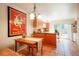 Open kitchen and dining area with wood cabinets, tile floors, and access to outdoor patio at 1578 S Syracuse St, Denver, CO 80231