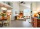 Bright, open living area featuring high ceilings, a cozy fireplace, stylish furnishings, and hardwood floors at 1578 S Syracuse St, Denver, CO 80231