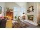 Inviting living room with lots of natural light from large windows, a brick fireplace, and comfortable seating at 1578 S Syracuse St, Denver, CO 80231