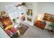 Bright living room with high ceilings, a ceiling fan, a fireplace, and large windows at 1578 S Syracuse St, Denver, CO 80231