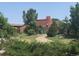 Two-story home with landscaped yard and unique architectural details at 9655 Morrison Rd, Lakewood, CO 80227