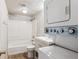 Bathroom with shower/tub combo, toilet and stackable washer/dryer at 875 S Quebec St # 24, Denver, CO 80247