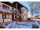 Building exterior with stairs, walkway, and small yard at 875 S Quebec St # 24, Denver, CO 80247