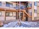 Exterior view of a two-story building with wooden stairs and railings at 875 S Quebec St # 24, Denver, CO 80247