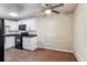 Modern kitchen with white cabinets, granite counters, and black appliances at 875 S Quebec St # 24, Denver, CO 80247