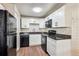 Updated kitchen features white cabinets, granite countertops, and modern appliances at 875 S Quebec St # 24, Denver, CO 80247