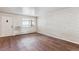 Living room with hardwood floors and an accent wall at 875 S Quebec St # 24, Denver, CO 80247