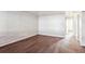 Living room with wood-look floors and an accent wall at 875 S Quebec St # 24, Denver, CO 80247