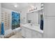 Bright bathroom features a shower-tub combo, single sink vanity, and a large mirror at 1074 S Dearborn St # 103, Aurora, CO 80012