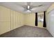 Bedroom features neutral carpet, ceiling fan, window, and closet, ready for personalization at 1074 S Dearborn St # 103, Aurora, CO 80012