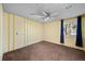 Cozy bedroom featuring soft carpet, a ceiling fan, and a bright window at 1074 S Dearborn St # 103, Aurora, CO 80012