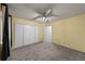 Bedroom features neutral carpet, ceiling fan, and a large closet at 1074 S Dearborn St # 103, Aurora, CO 80012