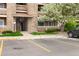 Charming condo building featuring stone accents, beige siding and vibrant flowering tree at 1074 S Dearborn St # 103, Aurora, CO 80012