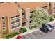 Aerial view of a well-maintained apartment building with stone accents and lush landscaping at 1074 S Dearborn St # 103, Aurora, CO 80012