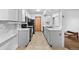 Efficient kitchen layout with white cabinets, tile flooring, and modern appliances at 1074 S Dearborn St # 103, Aurora, CO 80012