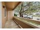 Inviting covered porch of a brown apartment with a lovely flowering tree nearby and ample parking at 1074 S Dearborn St # 103, Aurora, CO 80012
