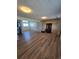 Spacious basement featuring hardwood floors, a rustic brick fireplace, and ample natural light at 275 Mckinley Dr, Bennett, CO 80102
