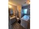 Cozy bathroom with vanity, toilet, shower, and washer/dryer combo at 275 Mckinley Dr, Bennett, CO 80102