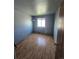 This bedroom features a large window offering natural light and wood flooring at 275 Mckinley Dr, Bennett, CO 80102