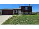 Charming home with a brick and wood exterior, complemented by a well-manicured front yard and an attached two car garage at 275 Mckinley Dr, Bennett, CO 80102