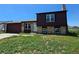 Charming home with a brick and wood exterior, complemented by a well-manicured front yard and an attached two car garage at 275 Mckinley Dr, Bennett, CO 80102