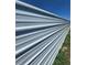 Modern metal fence provides privacy and security for the property, complemented by green vegetation at 275 Mckinley Dr, Bennett, CO 80102