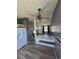 Open living area with hardwood floors, a modern ceiling fan, and seamless transition to the kitchen and staircase at 275 Mckinley Dr, Bennett, CO 80102