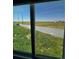 Wide backyard view showcasing vast grassy field, enclosed by a tall metal privacy fence at 275 Mckinley Dr, Bennett, CO 80102
